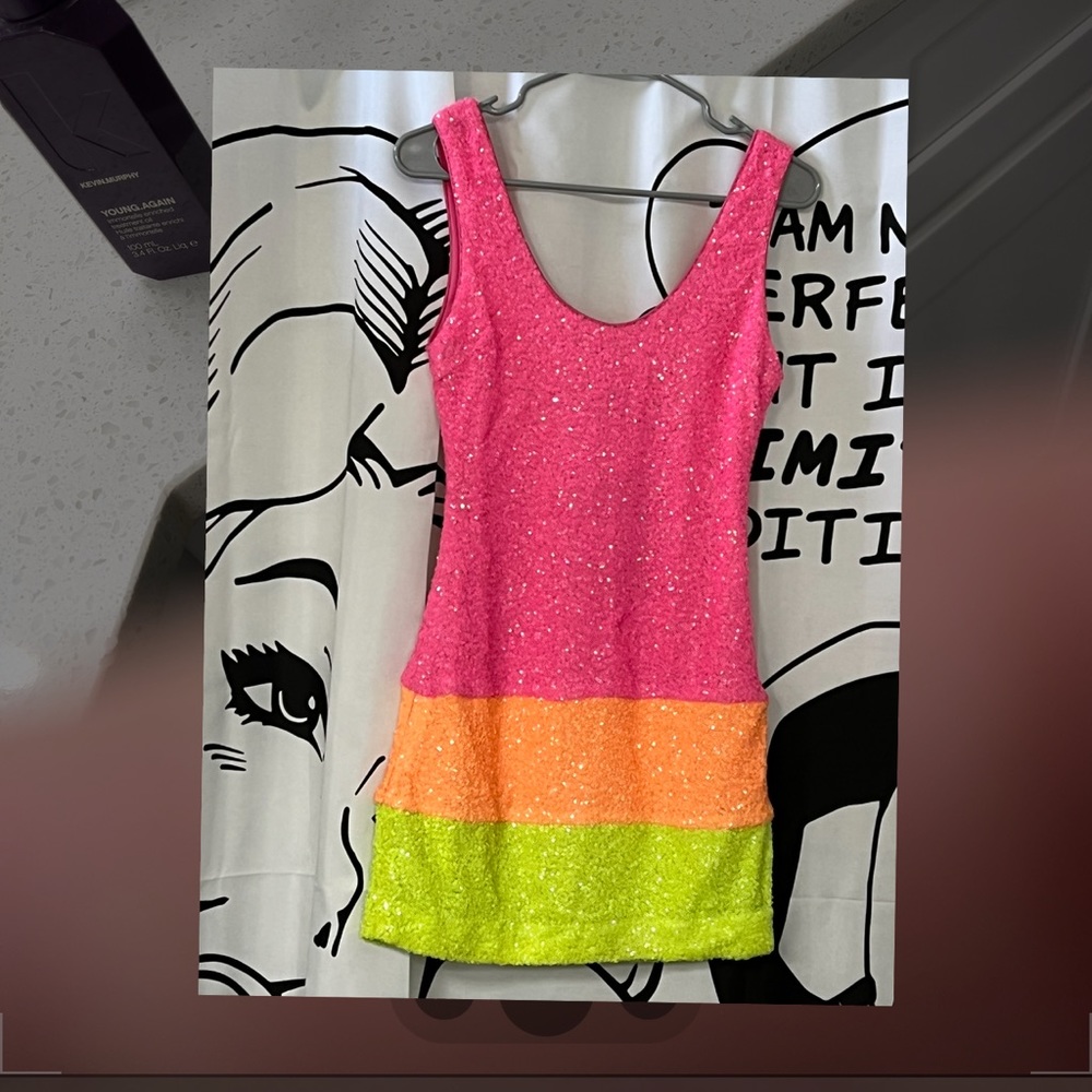 Stand out with this bright and super cute sequin dress!